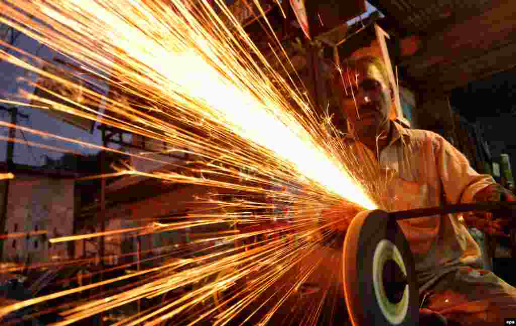 Blacksmiths sharpen various tools and knives to be used to sacrifice animals as Muslims across the world prepare for holy festival of Eid al-Adha, in Karachi, Pakistan. (epa/Shahzaib Akber)