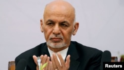 Afghan President Ashraf Ghani prays during a peace and security cooperation conference in Kabul on June 6.