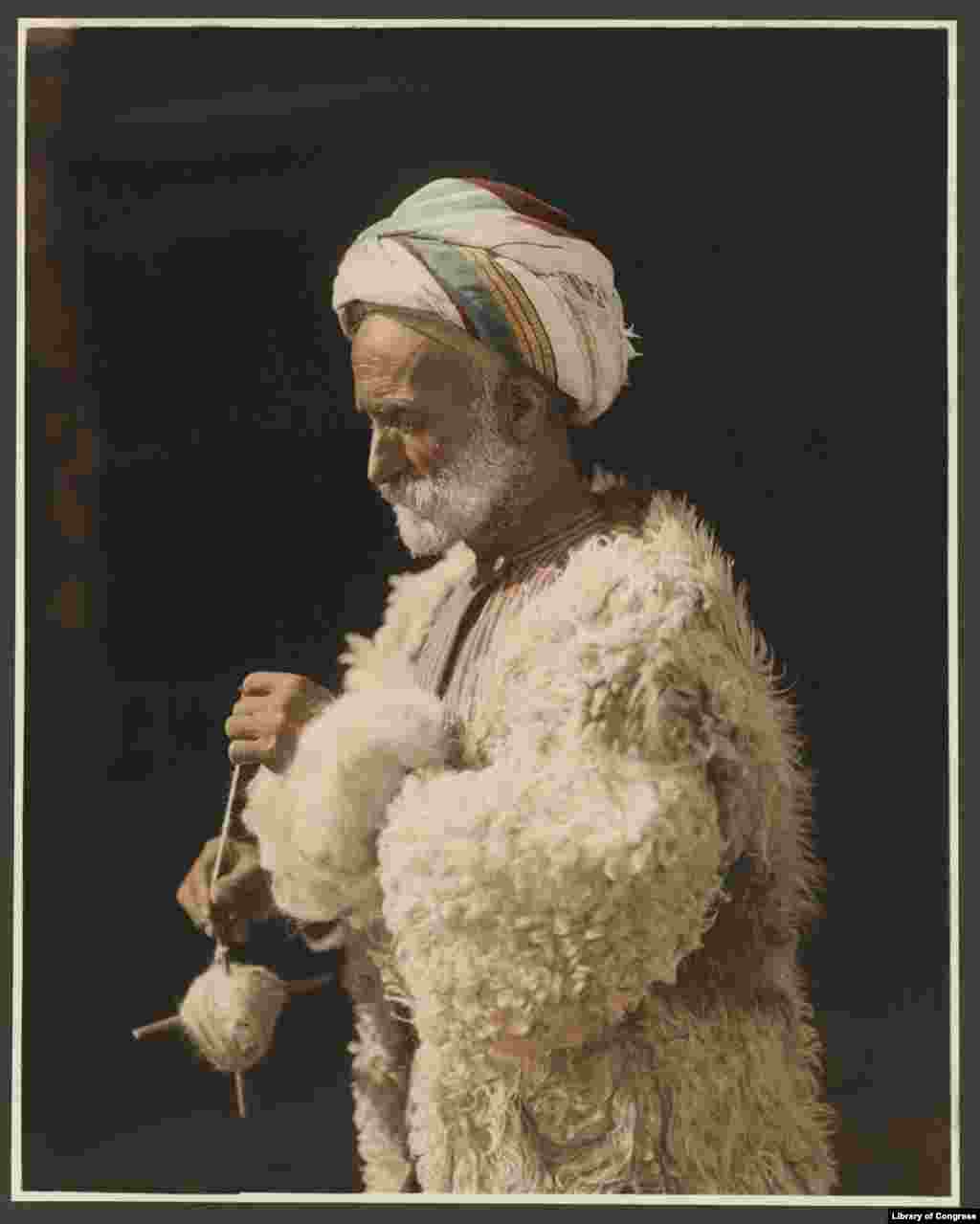 A Ramallah peasant spinning wool