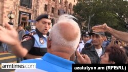 Armenia - A screen shot of video of police Lt. Artur Vardgesian slapping a protester in Yerevan, 21Aug2015.