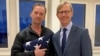 Michael White, a freed U.S. Navy veteran detained in Iran since 2018, poses with U.S. Special Envoy for Iran Brian Hook while on his return to the United States at Zurich Airport in Zurich, June 4, 2020