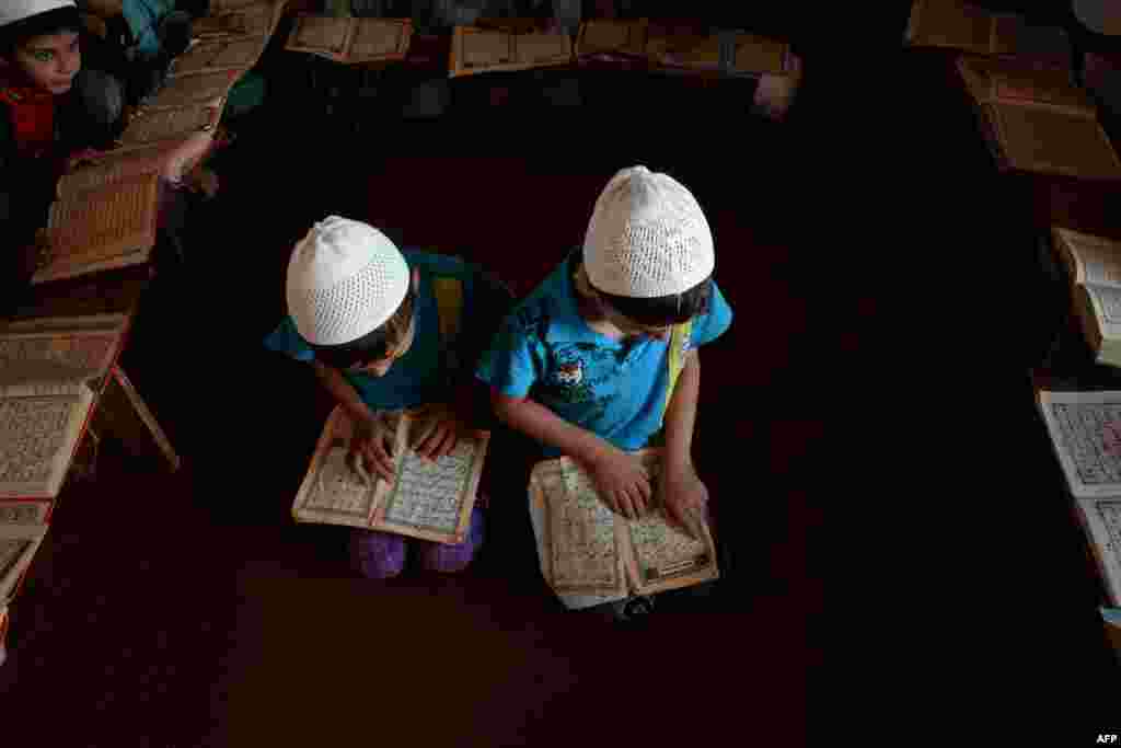 Afghan children read the Koran during the Islamic holy month of Ramadan at a mosque in Mazar-e Sharif. (AFP/Farshad Usyan)