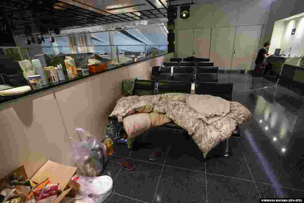 Food and blankets on benches at Tokyo International Airport. The Russian Embassy in Tokyo said it would provide health-care support if the travelers asked for help.