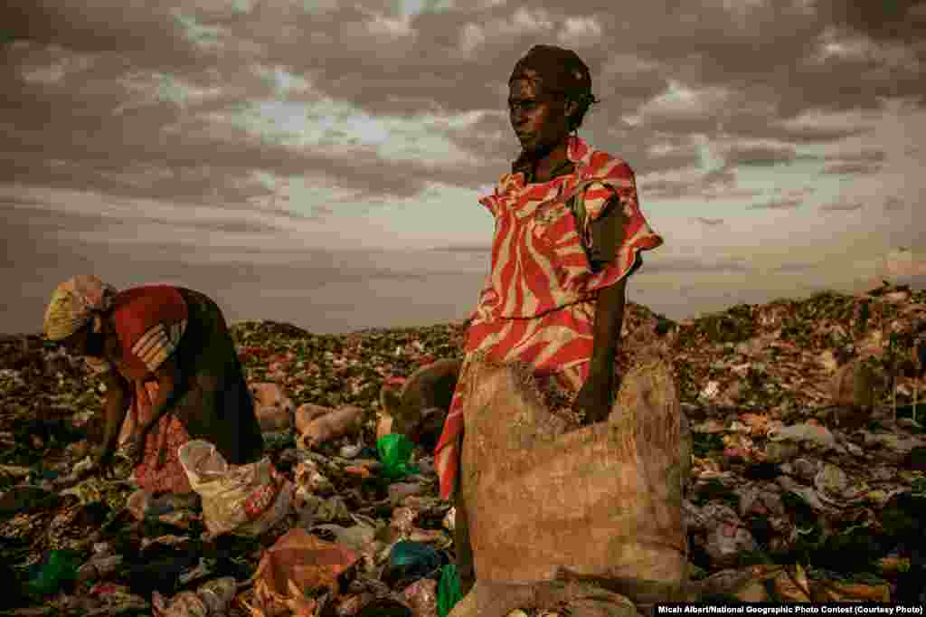 1st PLACE FOR PEOPLE: Amongst the Scavengers (Dandora Municipal Dump Site, near Nairobi, Kenya) -- At the end of the day, women are allowed to pick through the dumpsite. (Caption by photographer Micah Albert)