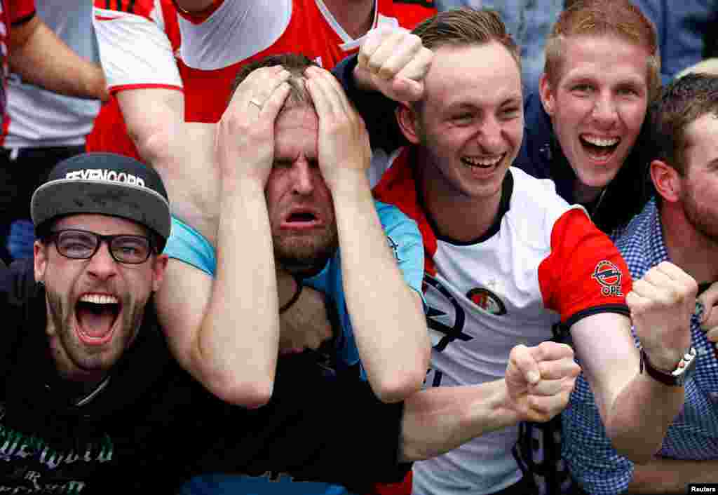 Soccer supporters react as Feyenoord Rotterdam score a goal in a Dutch league match against Heracles Almelo. (Reuters/Michael Kooren)