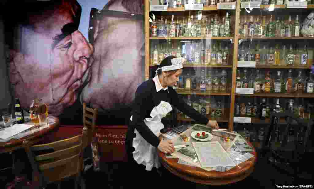 A waitress cleans tables in the buffet at the Vodka Museum in Moscow. (epa-EFE/Yuri Kochetkov)