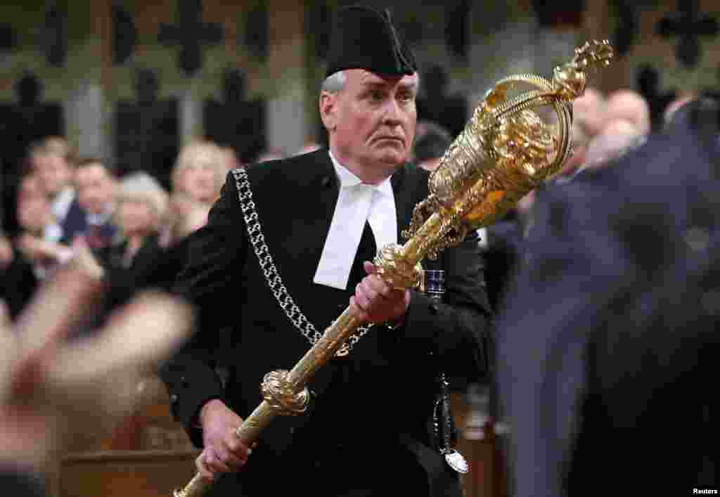 Sergeant-at-Arms Kevin Vickers is applauded in the House of Commons in Ottawa, Canada, on October 23. Vickers was credited with killing a gunman who went on a rampage in the Canadian parliament, killing a Canadian soldier before being shot by Vickers. (Reuters/Chris Wattie)
