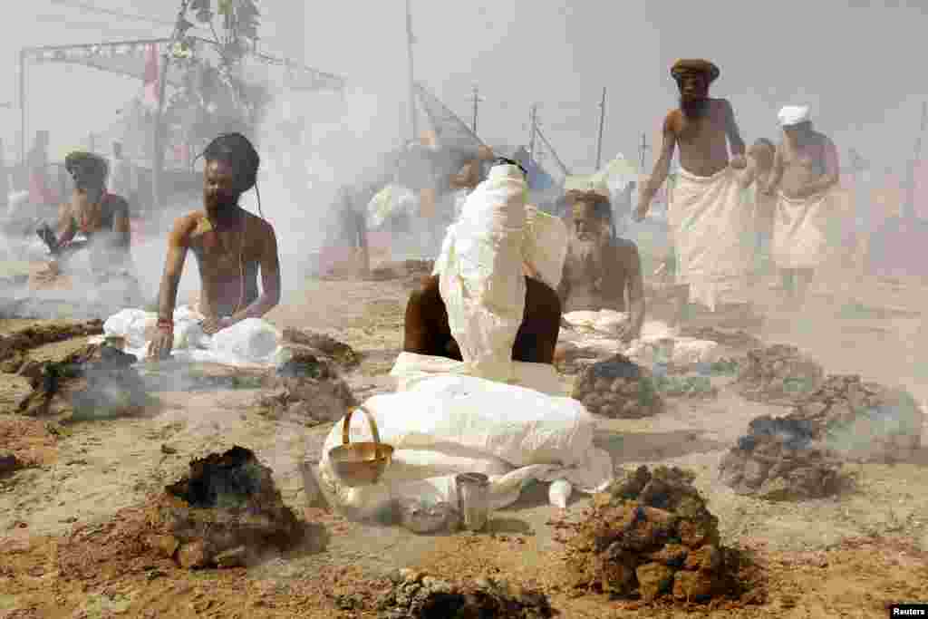 Sadhus, or Hindu holy men, perform prayers while sitting inside circles of burning &quot;upale&quot; (dried cow-dung cakes) on the banks of the River Ganges during the Magh Mela festival in the northern Indian city of Allahabad on February 4.&nbsp;(Reuters/Jitendra Prakash)