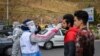 Health workers screening travelers on the road from the capital Tehran to Chaloos in the north of Iran. March 26, 2020. 