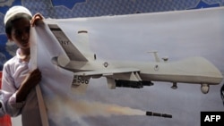 A Pakistani youth holds aloft a picture of a U.S. drone in Lahore during a protest against drone attacks in Pakistani tribal areas last year. 