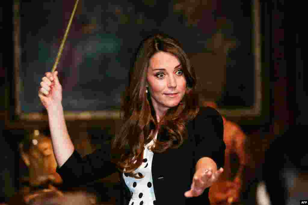 Britain's Catherine, duchess of Cambridge, tries a wand in the Harry Potter Tour during a visit to the inauguration of the Warner Bros. Studios Leavesden in north London. (AFP/Paul Rogers)