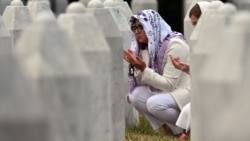 Women pray as they visit the graves of relatives at the memorial cemetery in the village of Potocari, near the town of Srebrenica in eastern Bosnia, on July 9, 2025.