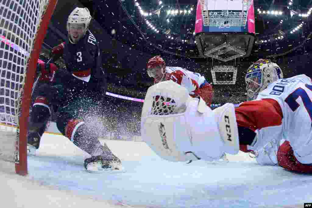 U.S. player Cam Fowler scores against Russia&#39;s goalkeeper, Sergei Bobrovski, during the Men&#39;s Ice Hockey Group A match. The United States beat Russia 3:2