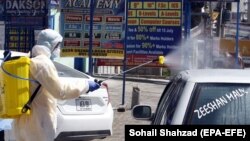 Pakistani workers spray disinfectant during a lockdown in the capital, Islamabad.