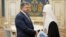 Ukrainian President Petro Poroshenko meets with Patriarch Filaret in Kyiv on April 18.