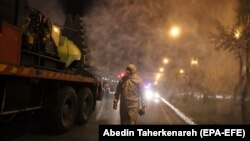 Iranian Firefighters disinfect streets in an effort to halt the spread of coronavirus in Tehran, March 11, 2020