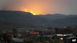 Explosions are seen over the mountains from Stepanakert, the main city of the breakaway Nagorno-Karabakh region, on October 30.