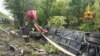 A firefighter stands next to an overturned tourist bus that crashed in Italy's Tuscany region on May 22.