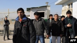 Afghan migrants leave the Kabul airport following their deportation from France on December 16.