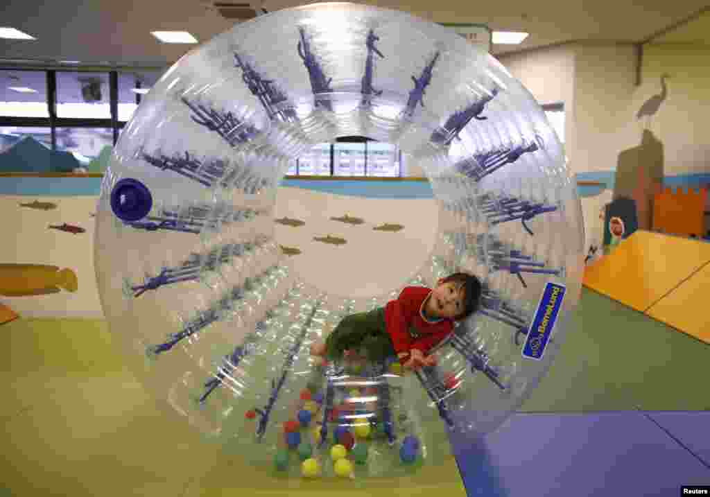 Two-year-old Sakuya Zui plays at an indoor playground.