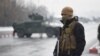 An Afghan security personnel guards the site of an attack near the Marshal Fahim Military Academy base in Kabul on January 29.