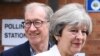 British Primer Minister Theresa May and her husband Philip arrive at a polling station near Reading, England, to cast their votes in the United Kingdom's general election on June 8.