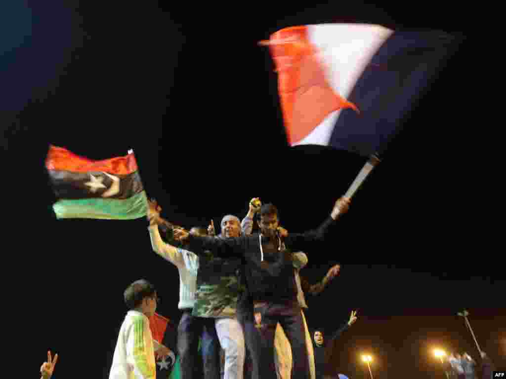 Libyans celebrate in Benghazi on March 17 the UN Security Council's resolution to impose a no-fly zone over Libya. Photo by Patrick Baz for AFP