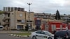 Police and emergency services surround the Bank of Georgia building in the city of Kutais on September 20 after a man took 14 people hostage.