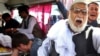 Relatives mourn a victim after a deadly suicide attack, in Kabul on June 11