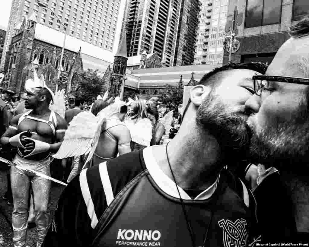 Muddy York Rugby Football Club player Jean Paul Markides (left) kisses his partner and teammate Kasimir Kosakowski during the Pride Parade on Sunday, 3 July 2016, in Toronto, Ontario. Sports -- First Prize, Stories (Giovanni Capriotti)&nbsp;