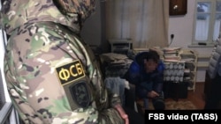 FSB officers detain Crimean Tatar activists after searching their homes In Crimea, Ukraine (file photo)