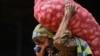 <p>A laborer carries a sack of potatoes at a wholesale vegetable market in Islamabad, Pakistan. 
