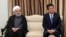 Japanese Prime Minister Shinzo Abe (right) and Iranian President Hassan Rohani in Tehran on June 13.