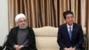 Japanese Prime Minister Shinzo Abe sits next to Iranian President Hassan Rohani (L) during a meeting with the supreme leader in Tehran, June 13, 2019