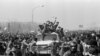 IRAN -- Ayatollah Khomeini Return from Exile 1979 -- Excited followers of the Ayatollah Khomeini, behind windshield, left, throng his motorcade as he leaves the airport for Behesht Zahra Cemetery, in Tehran, Iran, Feb. 1, 1979.