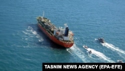 A photo made available by Iran's Tasnim news agency shows Iranian forces seizing the South Korean-flagged MT Hankuk Chemi in the Persian Gulf on January 4. 