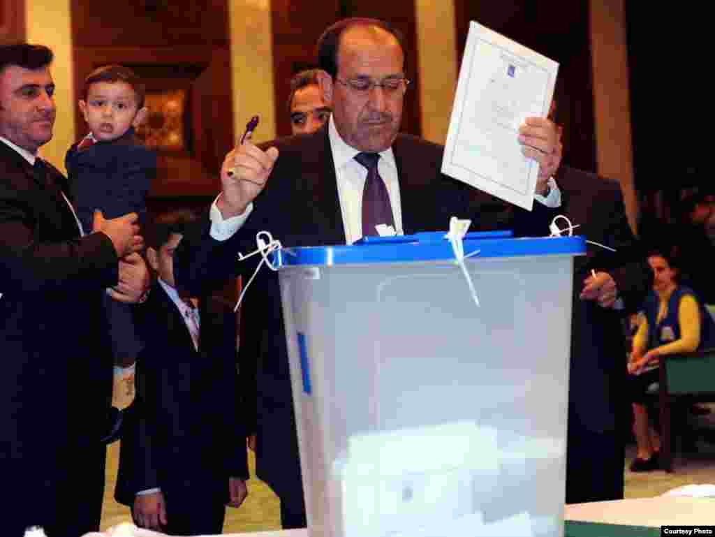 Iraqi Prime Minister Nuri al-Maliki casts his vote. 