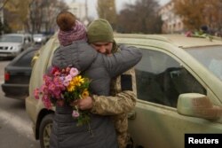 Un localnic din Herson îmbrățișează un soldat ucrainean, după ce trupele Kievului au preluat din nou controlul asupra orașului, în urma retragerii trupelor ruse.