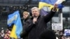 Former Ukrainian President Petro Poroshenko speaks to supporters who came to greet him at the airport upon his arrival in Kyiv on January 17. 