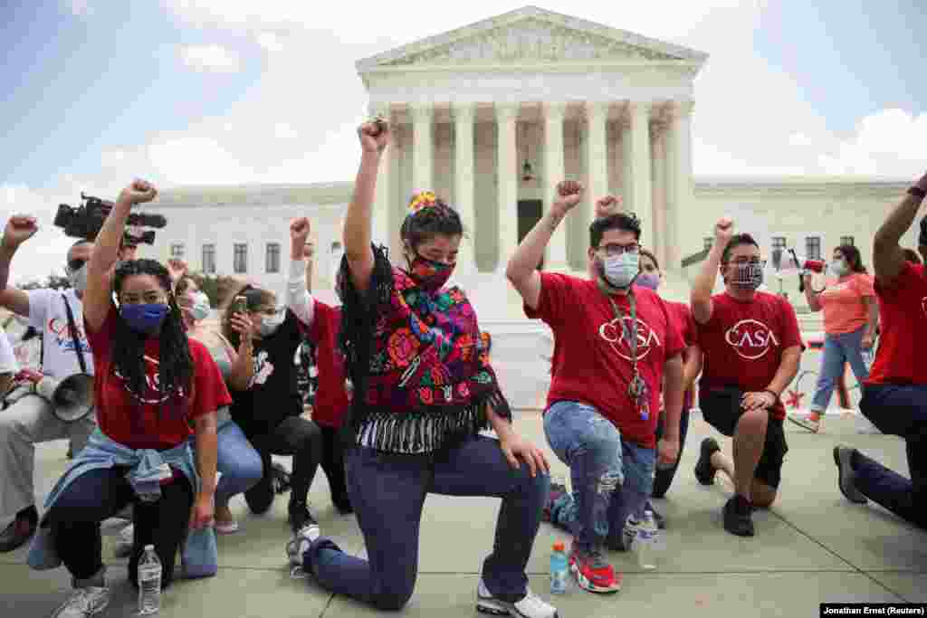 DACA recipients and their supporters take a knee in support of the Black Lives Matter movement, chating "Say their Names" and the names of Breonna Taylor and George Floyd, as they celebrate outside the U.S. Supreme Court after the court ruled in a 5-4 vote that U.S. President Donald Trump's 2017 move to rescind the Deferred Action for Childhood Arrivals (DACA) program, created in 2012 by his Democratic predecessor Barack Obama, was unlawful, in Washington, U.S. June 18, 2020. 