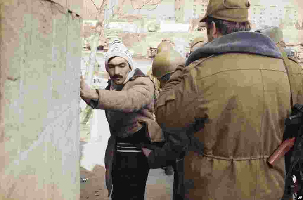 Soviet troops question a resident of the Azerbaijani capital on January 27 during a patrol to quell nationalist support.&nbsp;Thousands of Popular Front members and sympathizers were arrested and imprisoned.