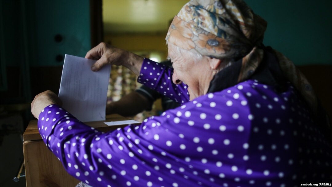 A voter in Slabada, outside the capital, Minsk, casts her ballot on September 11.
