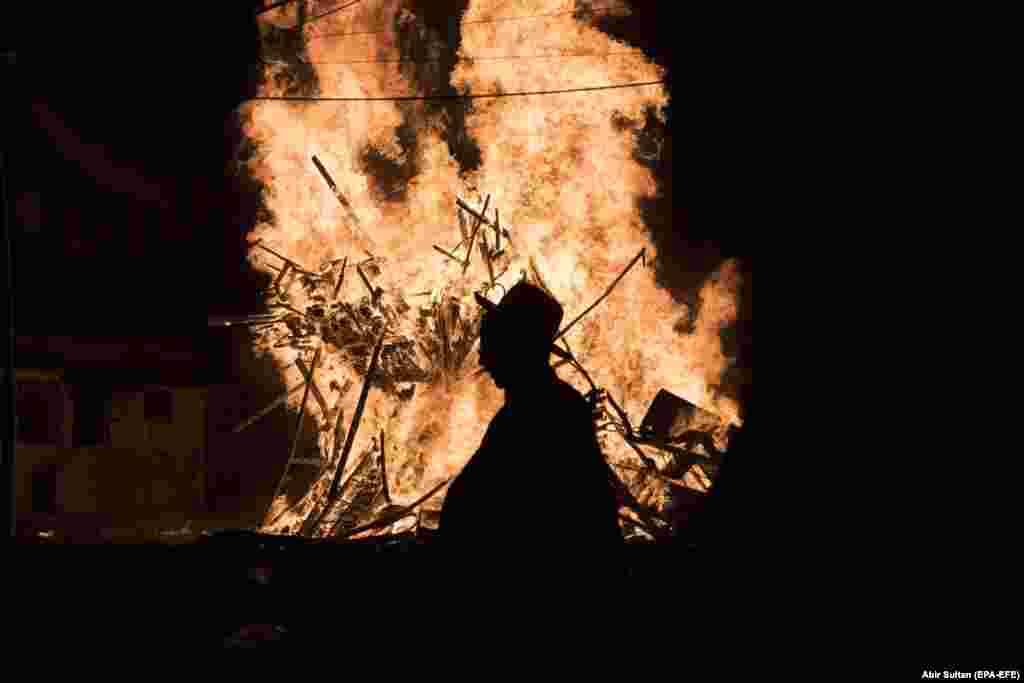 Ultra-Orthodox Jews dance around a large bonfire in the neighborhood of Mea Shearim in Jerusalem on May 2. (epa-EFE/Abir Sultan)