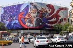 The Enqelab Square billboard depicting a hero from the epic Persian poem Shahnameh, battling a creature with the colors of the American flag.