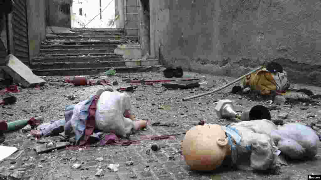 Toys are seen among the rubble of damaged shops in the Syrian city of Aleppo's al-Amereya district. (Reuters/Aaref Hretani)
