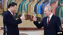Chinese President Xi Jinping and Russian President Vladimir Putin make a toast during a reception at the Kremlin in Moscow on March 21.