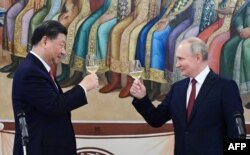Президент России Владимир Путин и председатель Китая Си Цзиньпин произносят тост во время приема по итогам переговоров в Кремле в Москве 21 марта 2023 года