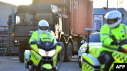 Police escort a British army truck carrying a freight container laden with Skripal’s car as part of the UK investigation into the nerve agent attack on Skripal in Salisbury, March 16, 2018.