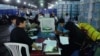 Afghan election workers sort ballot papers during an audit of the presidential runoff vote in the country's general election at a counting center in Kabul on August 25.