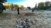 Police officers inspect a crater left by a part of an intercepted Russian missile in Kharkiv, Ukraine, on October 8. Zelenskiy also said his country has only 10 percent of what it needs for its air defense to repel Russian air strikes. 